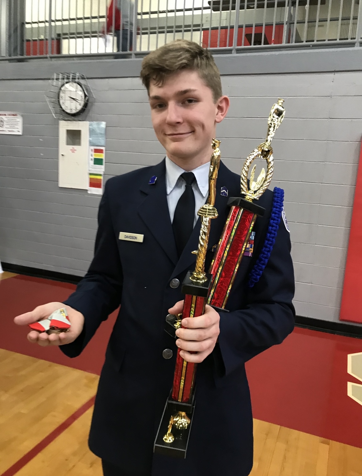 A young Trey holding an early drill competition trophy