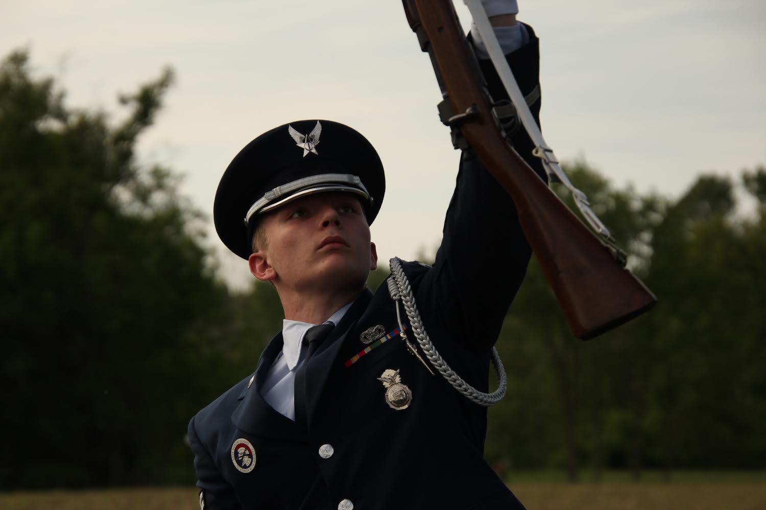 Trey standing with another cadet at an early national drill event